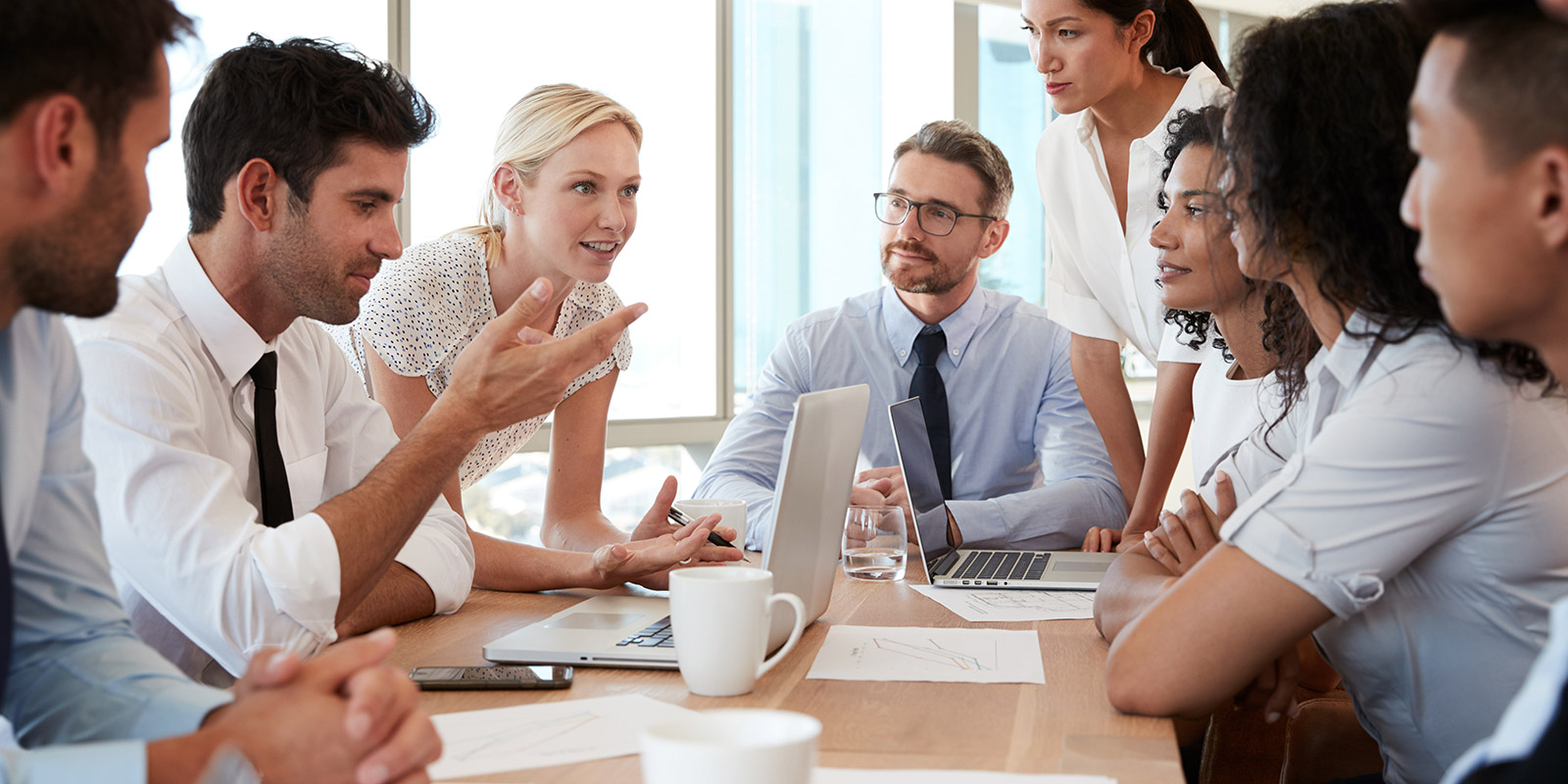 Group Of Businesspeople Meeting Around Table In Office