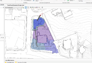 A computer screen displaying a site development plan with various colored overlays for different zones and contour lines, likely used for environmental or construction planning, incorporates the powerful OpenFlows analysis software for enhanced hydraulic modeling.